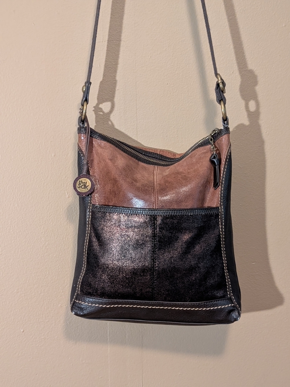 The Sak Brown and Black Leather Crossbody Bag.